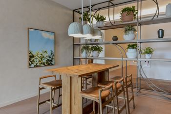 A dining area with a wooden table and chairs.